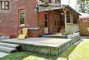 Expansive wood deck with lattice skirting, leading to a covered porch with wood railing and lattice accents - 781 Oakdale Avenue, Burlington, ON 