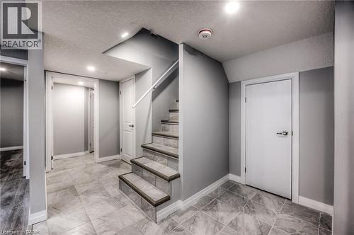 Staircase with tile treads and a white handrail - 33 Ruskview Road Unit# Lower, Kitchener, ON 