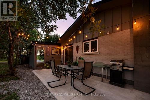New concrete patio under string lights - 139 Town Line, Orangeville, ON 