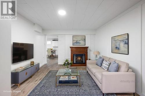 Bsmt living room with fireplace - virtually staged - 139 Town Line, Orangeville, ON 