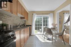 Bright kitchen with walkout to fenced yard - 