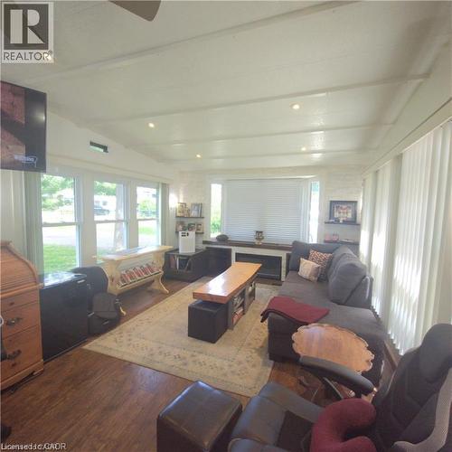 Wood-finish flooring, white exposed ceiling beams, recessed lighting, multiple windows, and a built-in media console - 580 Beaver Creek Road Unit# Lot 158, Waterloo, ON 