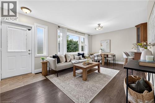 Expansive living area with wood-finish flooring, recessed lighting, and large windows - 176 Avalon Place, Kitchener, ON 