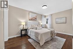 Wood-finish flooring, recessed lighting, and a contemporary ceiling fixture - 