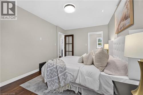 Wood-finish flooring, light neutral wall color, and a flush-mount ceiling light - 176 Avalon Place, Kitchener, ON 