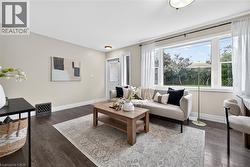 Expansive window, dark wood-finish flooring, recessed lighting, neutral wall tones, and crown molding - 