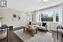 Expansive window, dark wood-finish flooring, recessed lighting, neutral wall tones, and crown molding - 176 Avalon Place, Kitchener, ON 