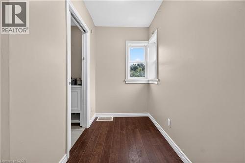 Wood-finish flooring, neutral wall paint, and white trim throughout - 176 Avalon Place, Kitchener, ON 