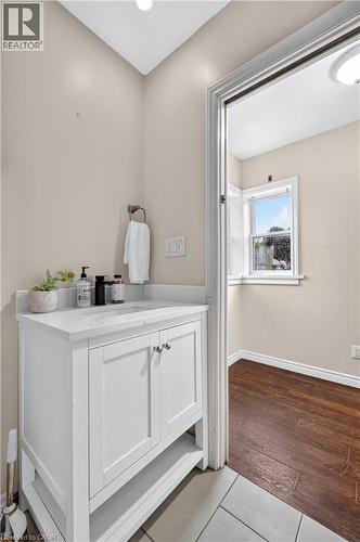 White vanity with a solid surface countertop and undermount sink - 176 Avalon Place, Kitchener, ON 