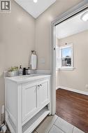 White vanity with a solid surface countertop and undermount sink - 