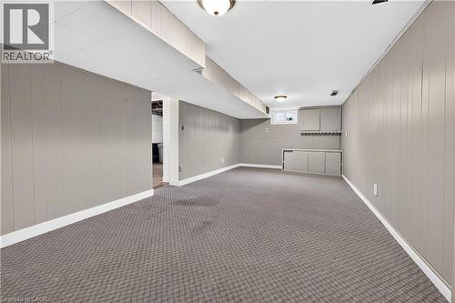 Finished lower level featuring neutral wall paneling, recessed lighting, built-in cabinetry, and patterned carpeting - 176 Avalon Place, Kitchener, ON 