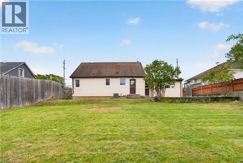 Expansive grassy yard with wood fencing and a detached structure - 176 Avalon Place, Kitchener, ON 