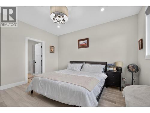 Spacious primary bedroom with a walk-in closet and private ensuite. - 2400 Hawks Boulevard, West Kelowna, BC 