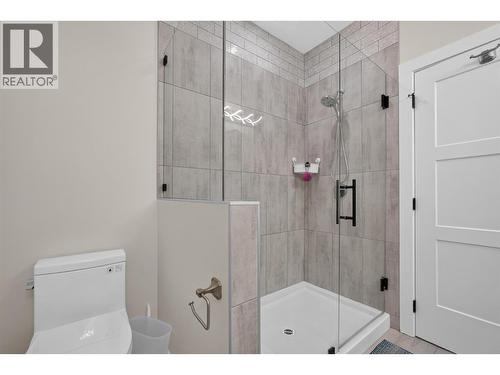 Primary ensuite with a fully tiled glass shower and modern finishes. - 2400 Hawks Boulevard, West Kelowna, BC 