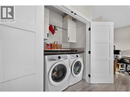 Convenient upstairs laundry located on the same floor as all three bedrooms, with built-in storage and hanging space - 2400 Hawks Boulevard, West Kelowna, BC 