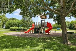 kid play structure in park across the street - 