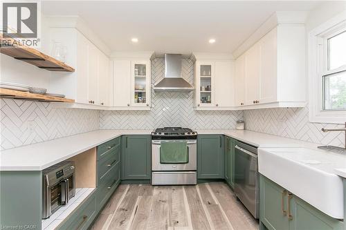 U-shaped kitchen with white upper cabinetry and sage lower cabinetry - 393 Huron Street, New Hamburg, ON 