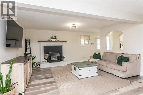 Recessed wood-finish flooring, white fireplace mantel, and an arched doorway - 393 Huron Street, New Hamburg, ON 