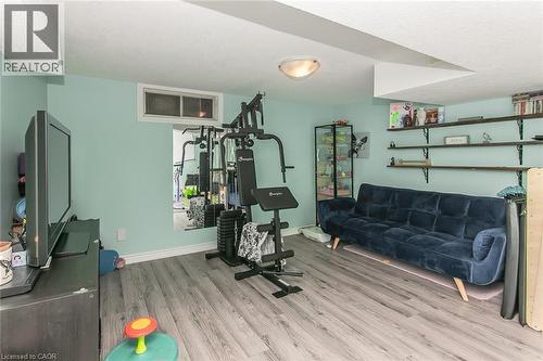 Recessed window, wood-finish flooring, ceiling-mounted light fixture, and built-in shelving - 393 Huron Street, New Hamburg, ON 