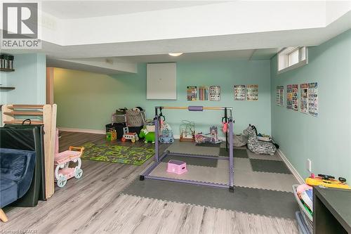 Lower-level space featuring wood-finish flooring, recessed lighting, and a window - 393 Huron Street, New Hamburg, ON 