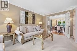 Crown molding detailing, cream-colored wall finishes, and carpeted flooring - 