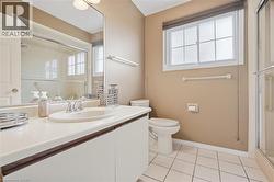 White tile flooring, single vanity with integrated sink, chrome faucet, mirrored medicine cabinet, and glass-enclosed shower - 