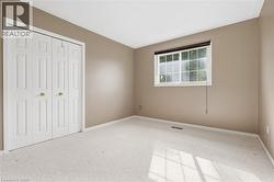 White paneled bi-fold closet doors with brass hardware - 