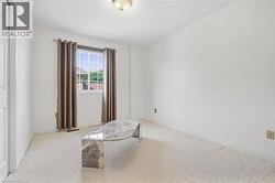 White painted walls with light-colored carpet flooring - 