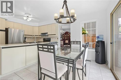 Light-toned cabinetry, stainless steel appliances, and a tile backsplash - 5 Michelle Drive, St. Catharines, ON 