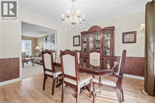 Wood-finish flooring with crown molding and chair rail detailing - 5 Michelle Drive, St. Catharines, ON 