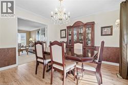 Wood-finish flooring with crown molding and chair rail detailing - 