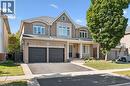 Brick facade with a covered entry and dual garage doors - 154 Falconridge Drive, Kitchener, ON 