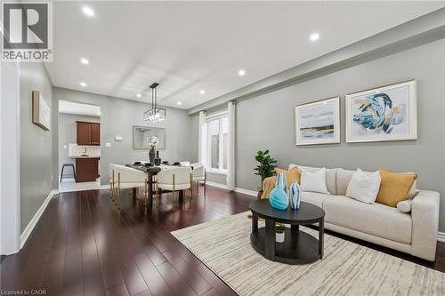 Recessed lighting, wood-finish flooring, and a modern rectangular chandelier - 154 Falconridge Drive, Kitchener, ON 