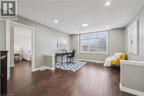 Hardwood flooring, recessed lighting, large window, chair rail molding, and an open doorway - 154 Falconridge Drive, Kitchener, ON 