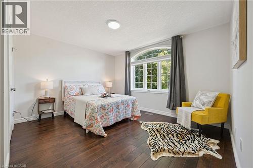 Dark wood-finish flooring with white baseboards - 154 Falconridge Drive, Kitchener, ON 