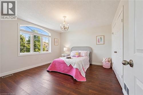 Arch-top window with transoms, wood-finish flooring, recessed lighting, and a crystal chandelier - 154 Falconridge Drive, Kitchener, ON 