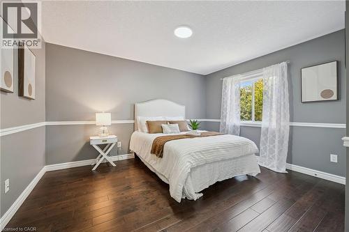 Wood-finish flooring, two-tone wall treatment, recessed ceiling light, and natural light from the window - 154 Falconridge Drive, Kitchener, ON 