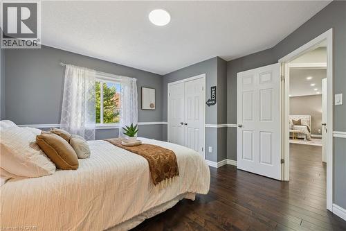 Hardwood flooring, painted walls with chair rail molding, white trim throughout, and a window with natural light - 154 Falconridge Drive, Kitchener, ON 