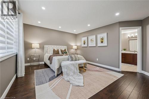 Spacious room with dark wood-finish flooring, recessed lighting, and a window with blinds - 154 Falconridge Drive, Kitchener, ON 