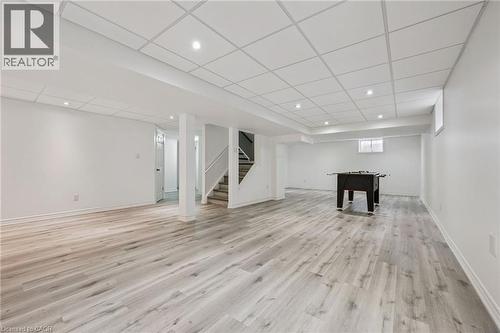 Finished basement with wood-finish flooring, recessed lighting, and a drop ceiling - 154 Falconridge Drive, Kitchener, ON 