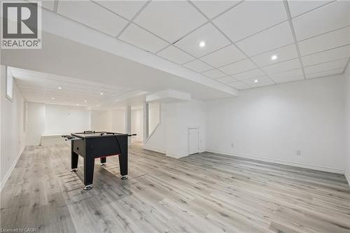 Spacious lower level featuring wood-finish flooring, recessed lighting, and a white drop ceiling - 154 Falconridge Drive, Kitchener, ON 
