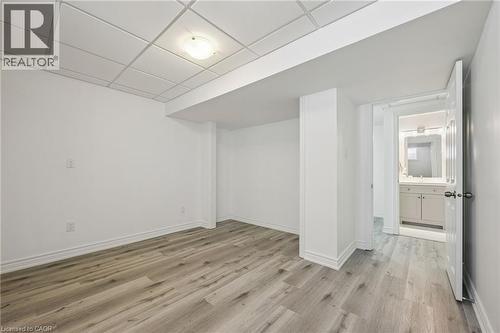 Wood-finish flooring, drop panel ceiling, and recessed lighting - 154 Falconridge Drive, Kitchener, ON 