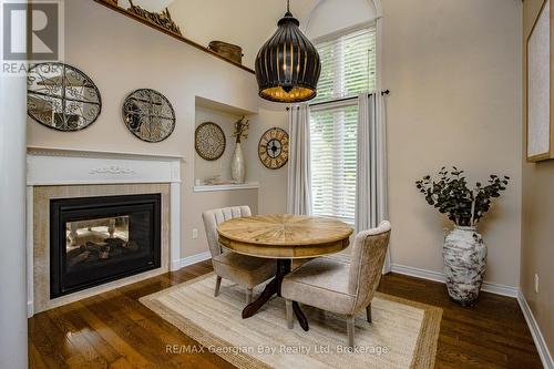 Dining room with 2 way gas fireplace - 68 Riverwalk Place, Midland, ON 