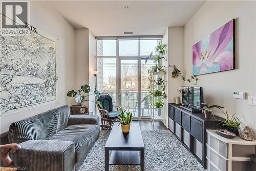 Floor-to-ceiling glass patio door, high ceilings, wood-finish flooring, and a neutral wall color - 2750 King Street E Unit# 103, Hamilton, ON 