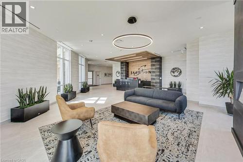 Lobby featuring large-format tile flooring and extensive window lines - 2750 King Street E Unit# 103, Hamilton, ON 