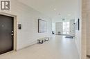 Modern corridor featuring light-toned tile flooring, recessed lighting, expansive windows, and textured wall coverings - 2750 King Street E Unit# 103, Hamilton, ON 