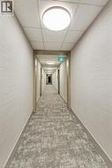 Corridor featuring patterned carpet, light wood-finish door frames, and flush-mount ceiling lighting - 