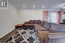 Recessed ceiling lights, crown molding, white wall finish, and wood-finish flooring - 