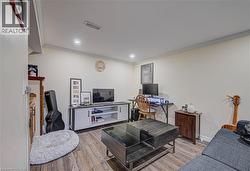 Wood-finish flooring, recessed lighting, and crown molding - 