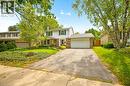 Two-story residence with white siding, brick accents, a two-car garage, and mature trees - 351 Craigleith Drive, Waterloo, ON 